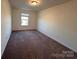 Bedroom with neutral walls, carpet, a window, and overhead lighting at 2623 Aubrey St, Monroe, NC 28110