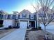 Charming townhome showcasing colorful exteriors, garage and well-maintained landscaping at 2623 Aubrey St, Monroe, NC 28110