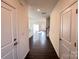 Inviting hallway featuring wood floors and leading to open living area at 2623 Aubrey St, Monroe, NC 28110