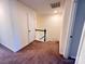 Carpeted hallway with stairs leading to another floor, and a door at the end of the hall at 2623 Aubrey St, Monroe, NC 28110