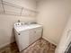 A laundry room with washer, dryer, and overhead shelving at 2623 Aubrey St, Monroe, NC 28110