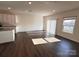 Bright living room with hardwood floors and sliding glass doors, open to kitchen at 2623 Aubrey St, Monroe, NC 28110