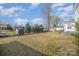 Expansive backyard view, showcasing lush lawn and surrounding trees and landscaping at 303 Bost St, Kannapolis, NC 28081