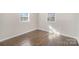 Cozy bedroom featuring hardwood floors and natural light from the windows at 303 Bost St, Kannapolis, NC 28081