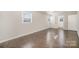 Spacious bedroom showcasing hardwood flooring, natural light, and neutral wall paint at 303 Bost St, Kannapolis, NC 28081