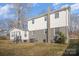 Rear exterior view of home with white siding and chimney, set on a spacious lawn at 303 Bost St, Kannapolis, NC 28081