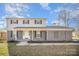 Charming two-story home with a welcoming front porch and manicured landscaping on a sunny day at 303 Bost St, Kannapolis, NC 28081