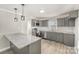 Kitchen featuring gray cabinets, stainless steel appliances, and a subway tile backsplash at 303 Bost St, Kannapolis, NC 28081