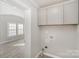 Utility room features built-in cabinets and laundry hook-ups at 303 Bost St, Kannapolis, NC 28081