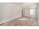 Bright living room featuring vinyl plank floors, ceiling fan, and ample natural light from windows at 303 Bost St, Kannapolis, NC 28081