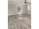 Bright living area featuring modern gray floors, neutral paint and a ceiling fan at 303 Bost St, Kannapolis, NC 28081