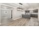 Open-concept living room with hardwood style flooring and a view of the kitchen and entry hall at 303 Bost St, Kannapolis, NC 28081