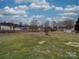 Large backyard with partial fencing, mature trees, and several neighborhood homes at 3114 Montcalm Ct, Monroe, NC 28110