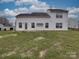 Back exterior of home featuring level yard, vinyl siding, and several windows at 3114 Montcalm Ct, Monroe, NC 28110