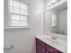 Well-lit bathroom with a dark vanity cabinet, a white sink, and a mirror at 3114 Montcalm Ct, Monroe, NC 28110