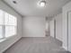 Well-illuminated bedroom features updated carpeting, neutral walls, and a window, ensuring a relaxing atmosphere at 3114 Montcalm Ct, Monroe, NC 28110