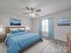 Serene bedroom with a cozy blue comforter, soft carpet, and natural light from the window at 3114 Montcalm Ct, Monroe, NC 28110