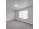 Cozy bedroom featuring a large window and neutral carpet at 3114 Montcalm Ct, Monroe, NC 28110