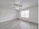 A bedroom with a ceiling fan and a window with white trim at 3114 Montcalm Ct, Monroe, NC 28110