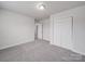 This bedroom features neutral carpet, fresh paint, and a closet with double doors at 3114 Montcalm Ct, Monroe, NC 28110