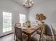 Well-lit dining room featuring a wooden table set for six, complemented by stylish decor at 3114 Montcalm Ct, Monroe, NC 28110