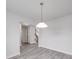 View of bright empty room with neutral walls and light-colored wood floor with staircase in the background at 3114 Montcalm Ct, Monroe, NC 28110