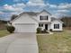 Charming two-story home with a well-maintained lawn and a two-car garage on a partly cloudy day at 3114 Montcalm Ct, Monroe, NC 28110