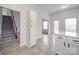 Bright kitchen features white cabinets, tile floors, and stainless steel appliances at 3114 Montcalm Ct, Monroe, NC 28110