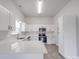 Well-lit kitchen features stainless steel appliances, white cabinets, and a quartz countertop at 3114 Montcalm Ct, Monroe, NC 28110