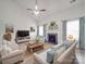 Bright living room with a fireplace, plush seating, and ample natural light from the large windows at 3114 Montcalm Ct, Monroe, NC 28110