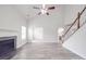 Open concept living room featuring fireplace, light gray flooring, and staircase at 3114 Montcalm Ct, Monroe, NC 28110