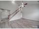 Spacious living room featuring a staircase and light-colored wood floor with neutral walls at 3114 Montcalm Ct, Monroe, NC 28110