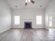 Spacious living room featuring a fireplace, neutral walls, and modern, light-colored flooring at 3114 Montcalm Ct, Monroe, NC 28110