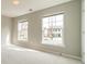 Sunlit bedroom with carpet and large windows at 3554 Laurenhurst Ln, Charlotte, NC 28270