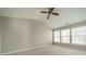 Spacious bedroom with vaulted ceiling, ceiling fan, and multiple windows at 3554 Laurenhurst Ln, Charlotte, NC 28270