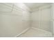 Walk-in closet with metal shelving and carpeted floor at 3554 Laurenhurst Ln, Charlotte, NC 28270