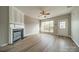 Spacious living room featuring a fireplace, ceiling fan, and bright windows at 3554 Laurenhurst Ln, Charlotte, NC 28270