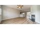 Open-concept living room with fireplace flowing into dining area at 3554 Laurenhurst Ln, Charlotte, NC 28270