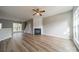 Spacious living room featuring a fireplace, ceiling fan, and bright windows at 3554 Laurenhurst Ln, Charlotte, NC 28270