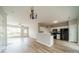 Open-concept living room flowing into a kitchen with modern black appliances at 3554 Laurenhurst Ln, Charlotte, NC 28270