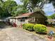 Rear view of house with brick and siding, well-maintained landscaping, and a concrete patio area at 3701 Seaman Dr, Charlotte, NC 28217