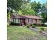 Charming brick home featuring a well-manicured lawn and beautiful, purple accents on the door and shutters at 3701 Seaman Dr, Charlotte, NC 28217