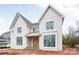 Stately two-story home showcasing a brick facade, arched front door, and large windows providing an abundance of natural light at 410 Wingrave Dr, Charlotte, NC 28270