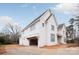 Expansive two-story home featuring an attached garage, round window accent, and ample outdoor space, blending modern charm at 410 Wingrave Dr, Charlotte, NC 28270