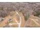 Aerial view of a wooded property with a long driveway, outbuildings, and a home at 4187 Bessie Hudson Rd, Lancaster, SC 29720