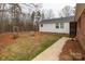 Backyard featuring a green lawn, a small bench swing, and access to the home's exterior at 4187 Bessie Hudson Rd, Lancaster, SC 29720