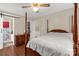 Bedroom featuring a wooden canopy bed, hardwood floors, ensuite access, and a ceiling fan at 4187 Bessie Hudson Rd, Lancaster, SC 29720