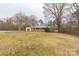 Wide shot of a home with a green metal roof with bare trees surrounding at 4187 Bessie Hudson Rd, Lancaster, SC 29720