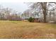 Exterior showing a brick home featuring a green metal roof, classic shutters, and mature trees at 4187 Bessie Hudson Rd, Lancaster, SC 29720