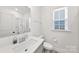 Well-lit bathroom featuring a single window, and a shower/tub combo, offering a clean and functional space at 4233 Poplin Grove Dr, Indian Trail, NC 28079